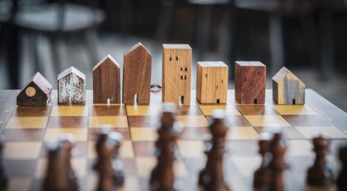 House models lined up on chess board