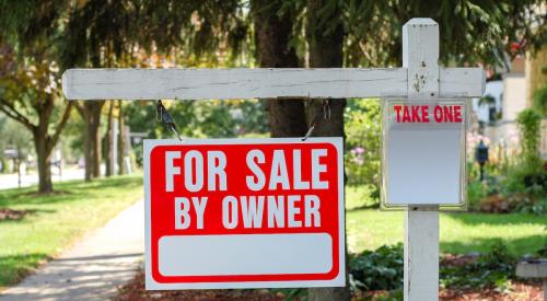 For-sale by owner sign outside of residential home