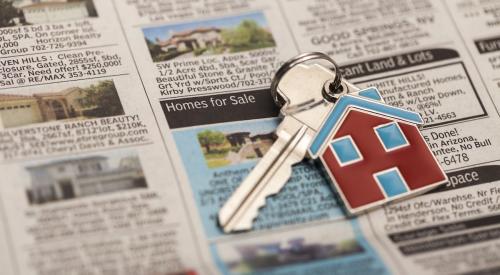 House keys on top of home listings in newspaper