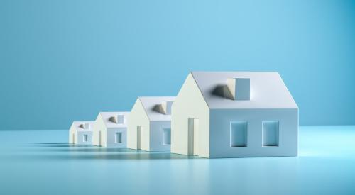 White houses increasing in size against a blue background