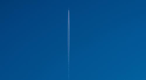 Plane flying up in blue sky