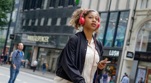 Woman walking down street | Millennials face record levels of student loan debt, home value growth surpassing wage growth, and more in the homebuying process. A new study finds where they're buying. 