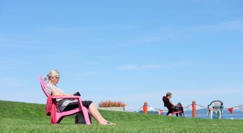 Baby boomer in pink Adirondack chair
