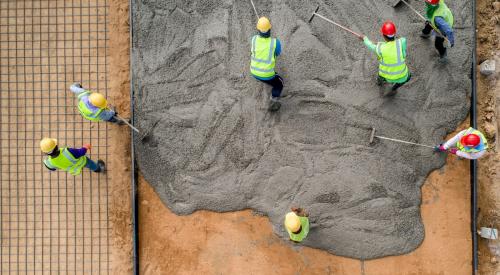 construction labor spreading concrete