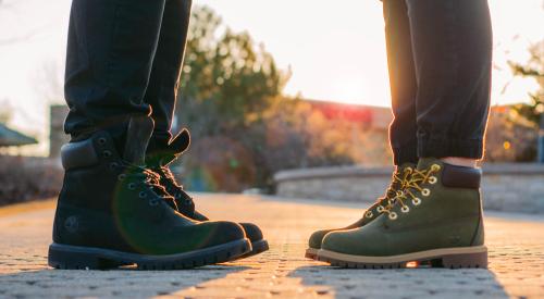 Two people standing in front of each other in boots