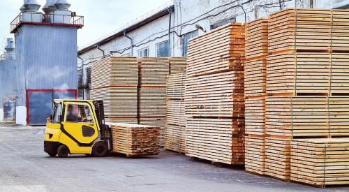 Lumber pallets being transported in warehouse