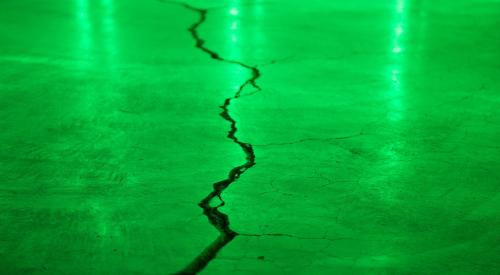 Crack in concrete with green light