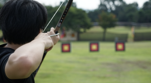 Man fires arrow at target