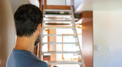 home inspector assessing staircase and other features in home