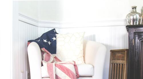 House interior with American flag and boots by chair