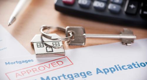 Approved stamp on mortgage application with house keys