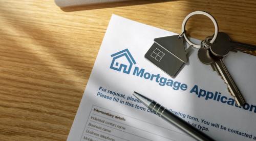 Mortgage application form and house keys on table 