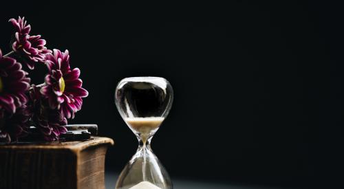 Hourglass on a table with flowers