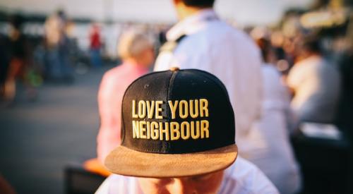 Man_wearing_Love_your_neighbor_cap