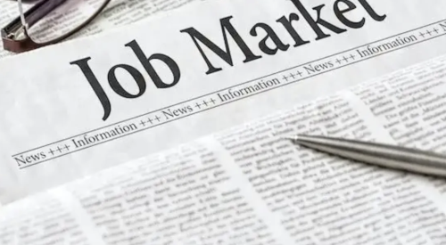 Jobs market report with pen and reading glasses