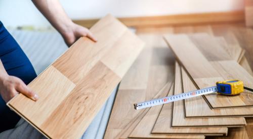 Person remodeling wooden home flooring