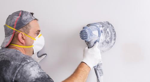 Removing dust with mask on