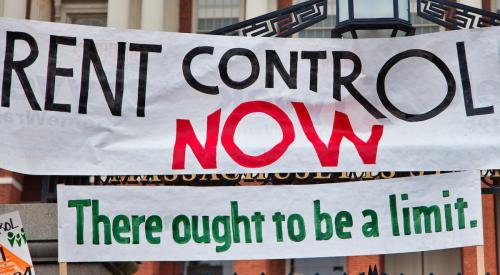 Banner at housing protest calling for rent control