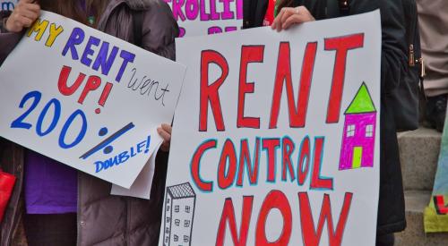 Rent control protestors with colorful signs