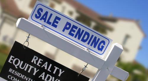 Sale pending marker above real estate sign