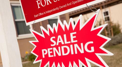 Sale pending sign under real estate sign