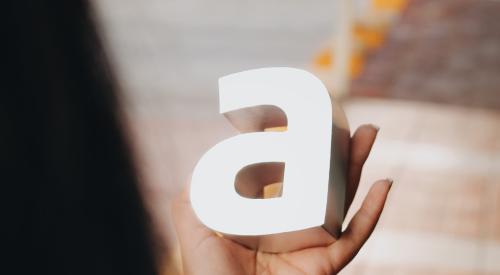 Person holding an "A" letter in their hand