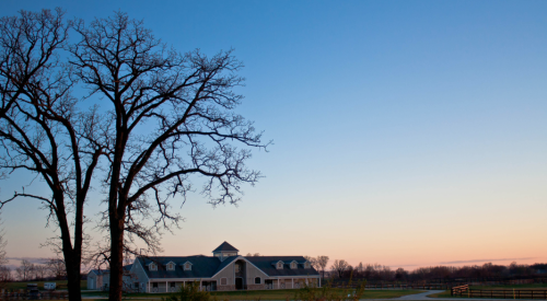 Sunset_behind_farm_building