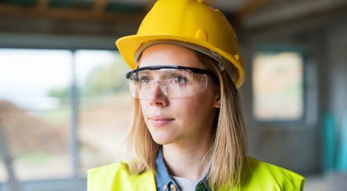 Woman looking determined at construction site