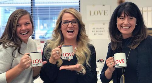 Women of CBH Homes holding coffee mugs